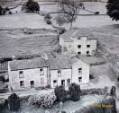 The view southwards from the church tower showing cottages on the Harkerside road. The building set back from the road is the Grinton Corn Mill. It was demolished in the early 1950s. The lady in the doorway of Mill Cottage was Mr. Mason's mother. More information is given on the Grinton village/houses section of this website.